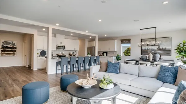 a living room with furniture kitchen view and a table