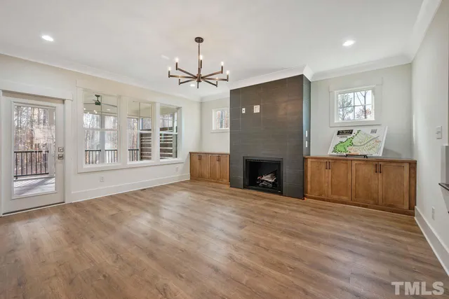 a view of a livingroom with a fireplace and window