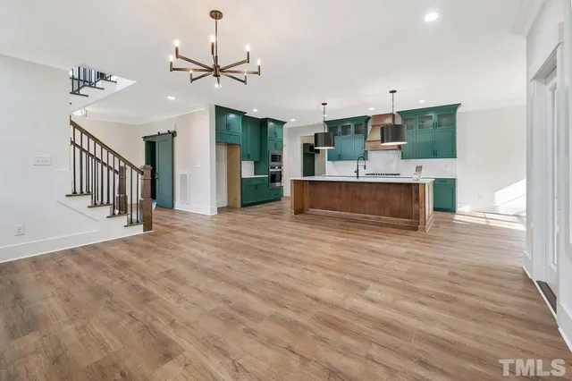 a view of a living room and kitchen with a flat screen tv
