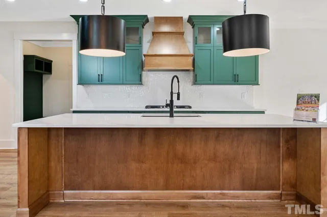 a kitchen with a sink and a refrigerator