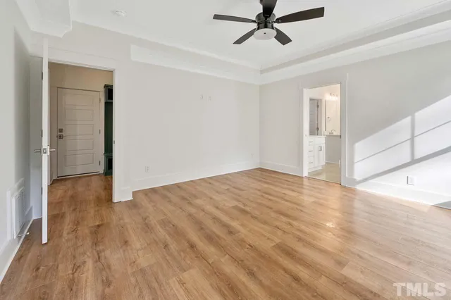 a view of a livingroom with wooden floor and white walls