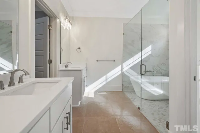 a en suite bathroom with a sink a mirror and a shower