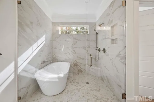 a bathroom with a granite countertop bathtub shower and toilet