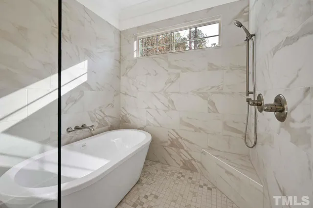 a bathroom with a bathtub and shower