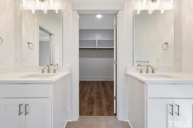 a bathroom with a sink double vanity and a mirror