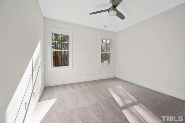 a view of a room with a ceiling fan
