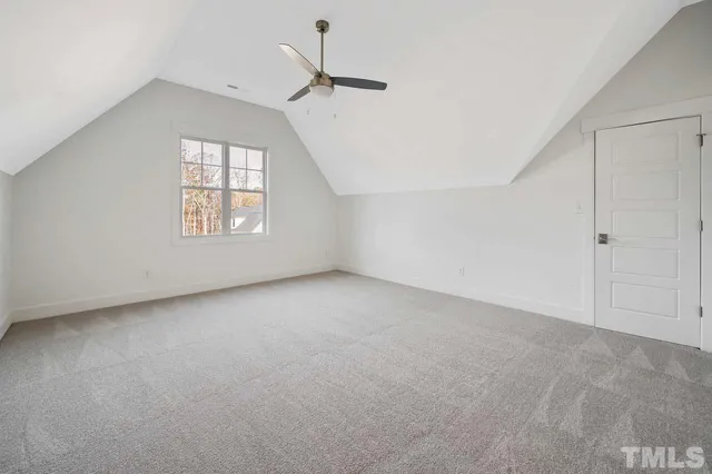 a view of an empty room with a ceiling fan