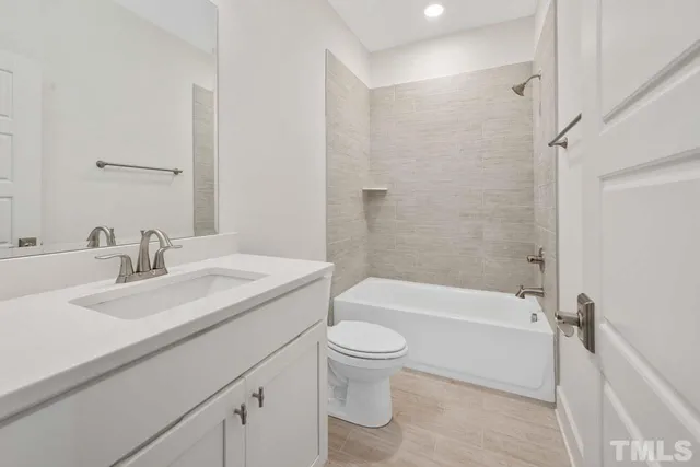 a bathroom with a double vanity sink mirror and toilet