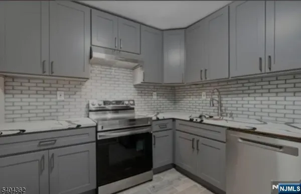 a kitchen with a sink stove and cabinets