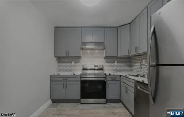 a kitchen with stainless steel appliances granite countertop a stove and a refrigerator
