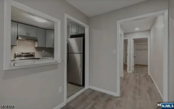 a kitchen with a refrigerator and a stove top oven