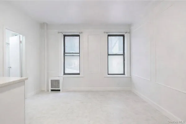 a kitchen with white cabinets and white appliances