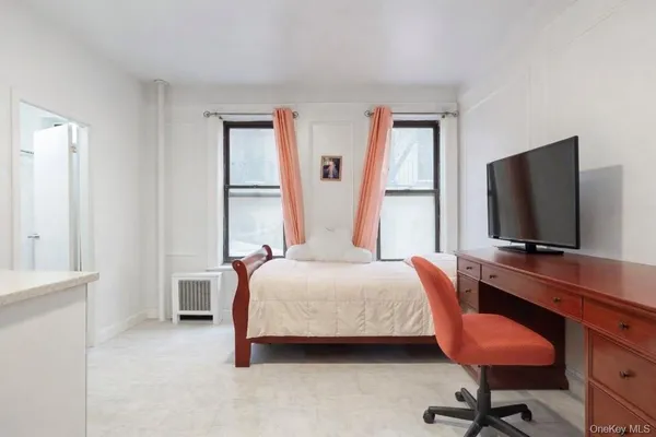 a bed room with a bed and a chair