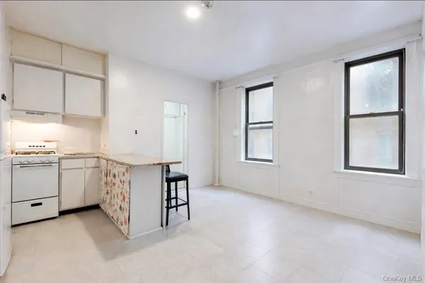 a kitchen with a stove and a clock