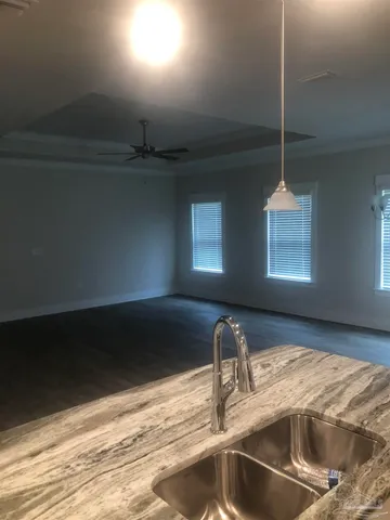 a kitchen with a sink and chandelier