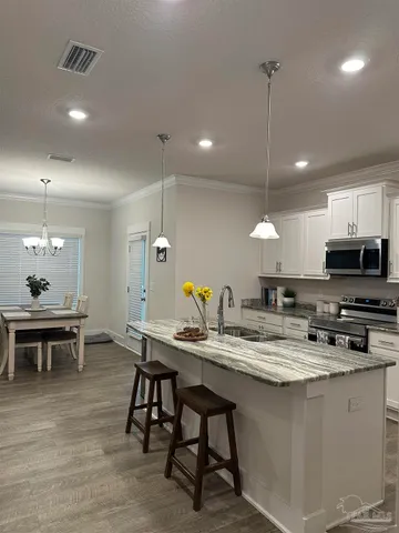 a kitchen with a dining table chairs and microwave