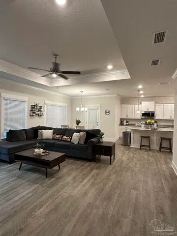a living room with furniture and kitchen view
