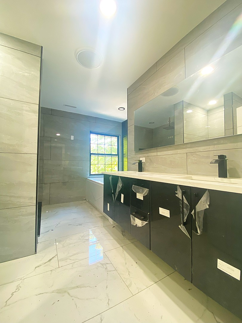 860 Green Bay Road Highland Park, IL 60035 - Photo 13 of 30 a bathroom with a sink shower and a mirror