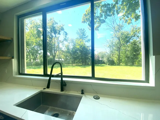 a bathroom with a sink and a large window