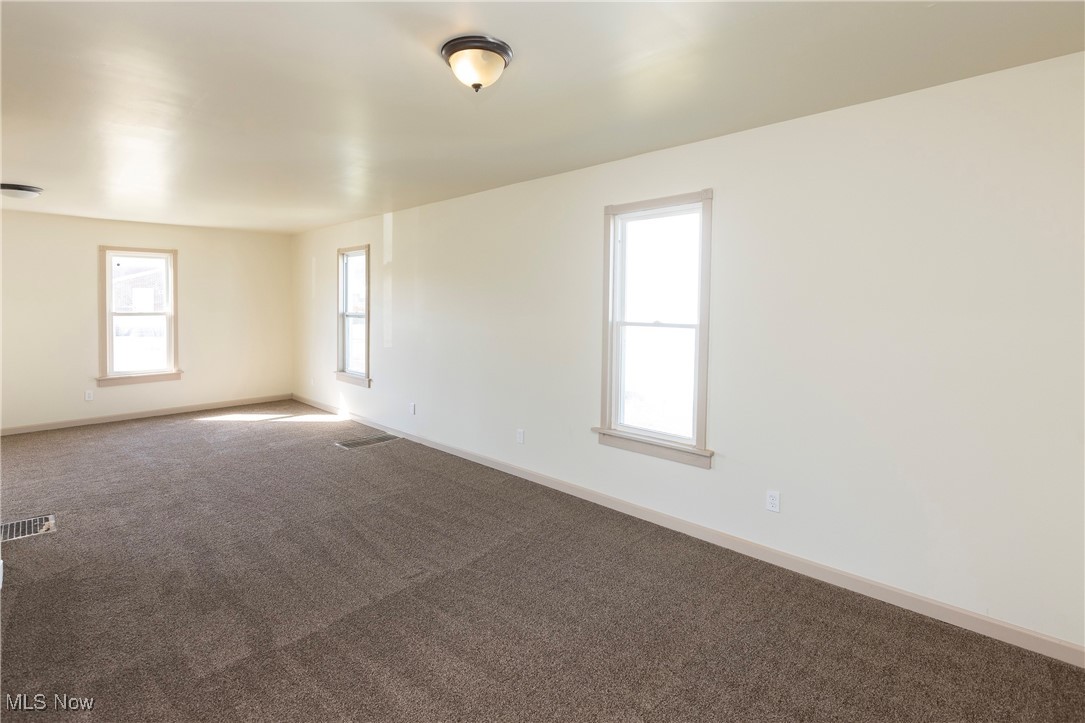 41957 North Ridge Road Elyria, OH 44035 - Photo 5 of 29 Carpeted empty room featuring visible vents and baseboards
