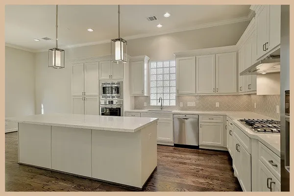 a kitchen with stainless steel appliances kitchen island granite countertop a sink stove and cabinets