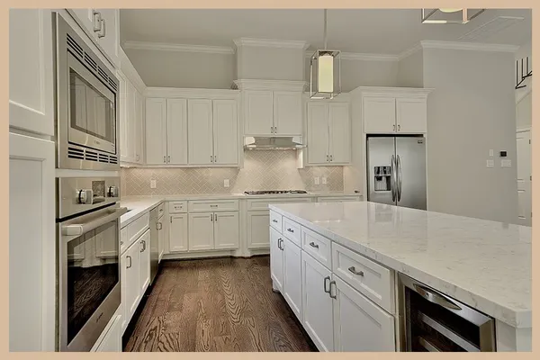 a kitchen with granite countertop white cabinets and white appliances