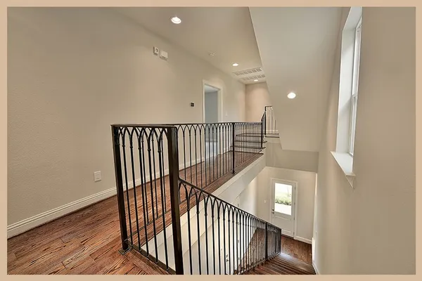 a view of staircase with railing and a rug