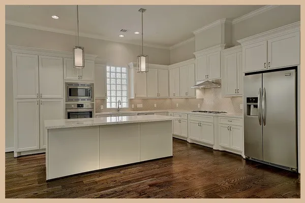 a kitchen with white cabinets and stainless steel appliances