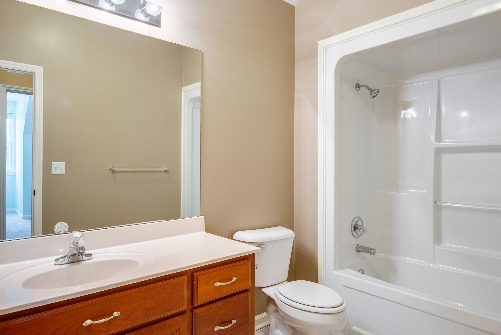1268 Camp Ravine Road Burns, TN 37029 - Photo 22 of 30 a bathroom with a sink a toilet and shower