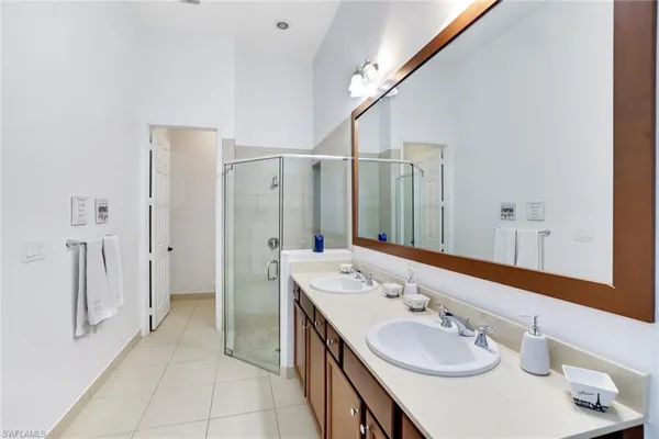 a spacious bathroom with a double vanity sink and a mirror