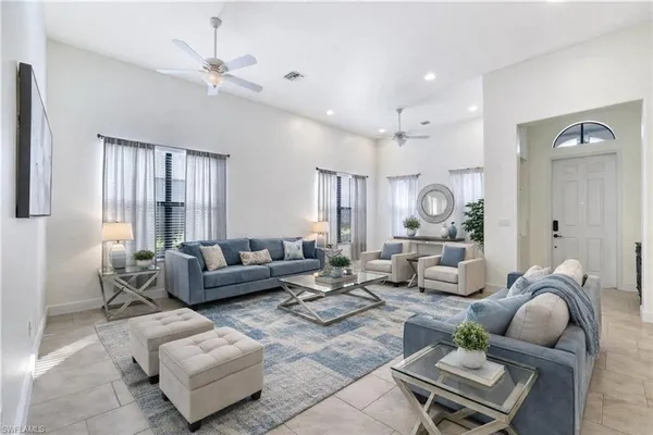a living room with furniture and a large window
