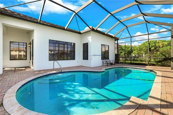 a swimming pool with outdoor seating