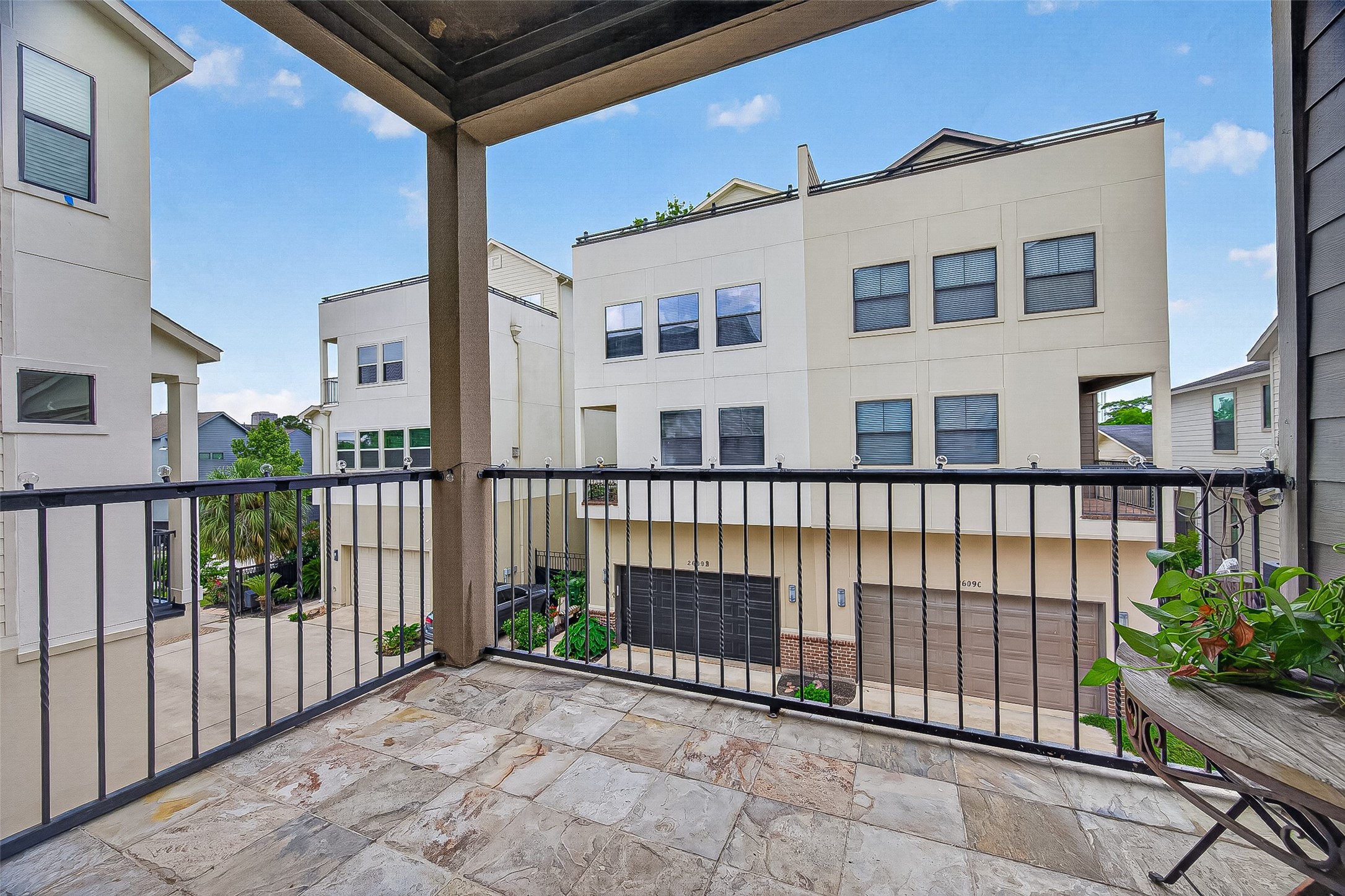 2611 Riverside Drive, Unit C Houston, TX 77004 - Photo 5 of 50 Beautiful covered balcony with elegant tile flooring, overlooking a secure gated community. This inviting outdoor space offers the perfect setting to relax, enjoy the peaceful view, and unwind with a good book and a glass of wine.
