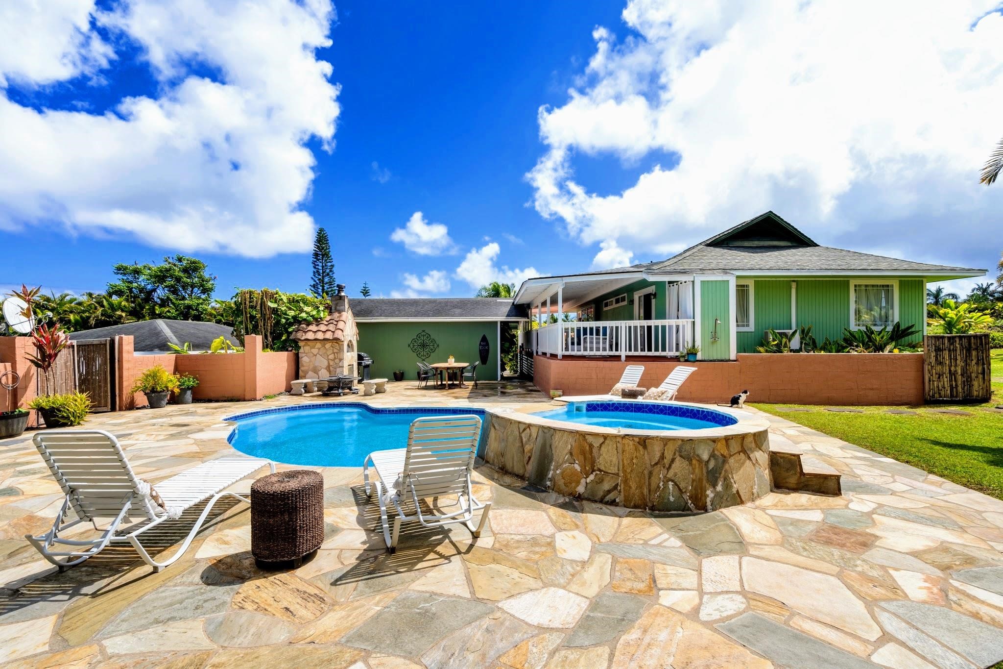 a view of a house with swimming pool and sitting area