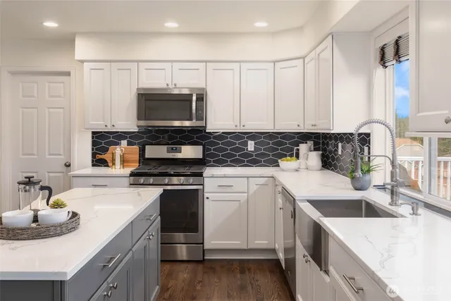 a kitchen with granite countertop a sink stove and cabinets