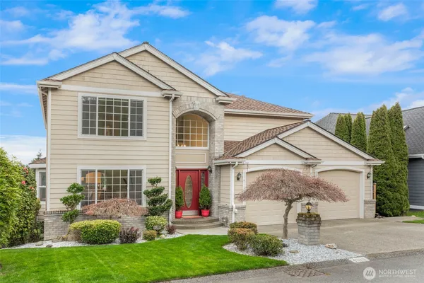 a front view of a house with a yard and garage