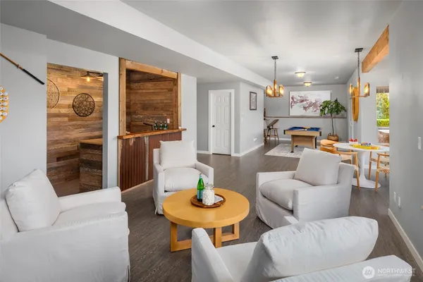 a living room with furniture kitchen view and a large window