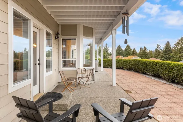 a view of a patio with table and chairs and potted plants