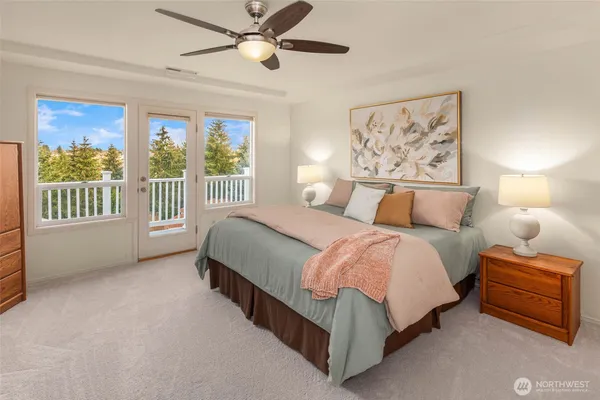 a spacious bedroom with a bed and a large window
