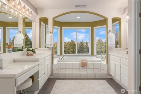 a large bathroom with a large tub and sink