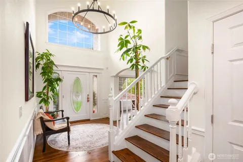 a view of staircase with furniture and a potted plant