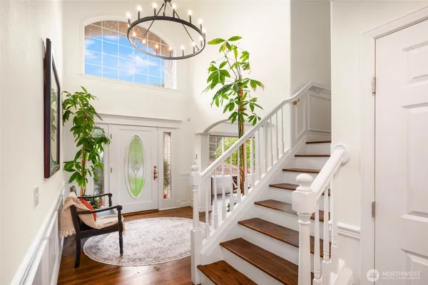 a view of staircase with furniture and a potted plant