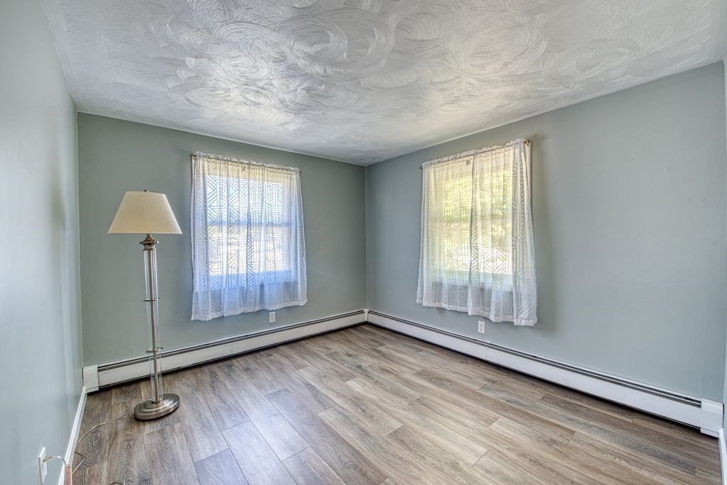 81 Errol Road Brockton, MA 02302 - Photo 11 of 31 an empty room with wooden floor and windows