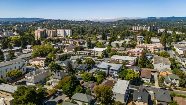 an aerial view of residential houses with city view