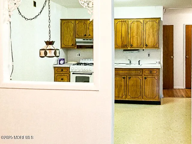a kitchen with stainless steel appliances a stove a sink and a refrigerator