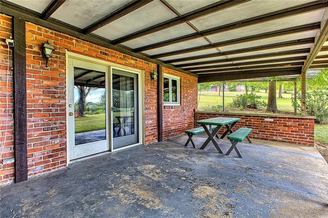 a backyard of a house with yard table and chairs