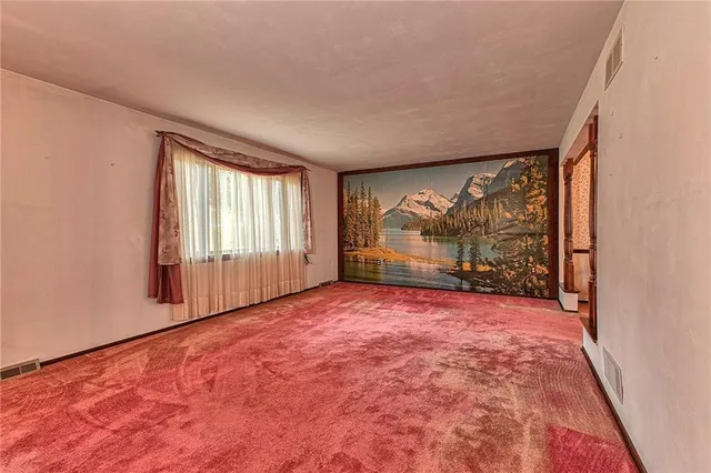 a view of empty room with floor to ceiling window