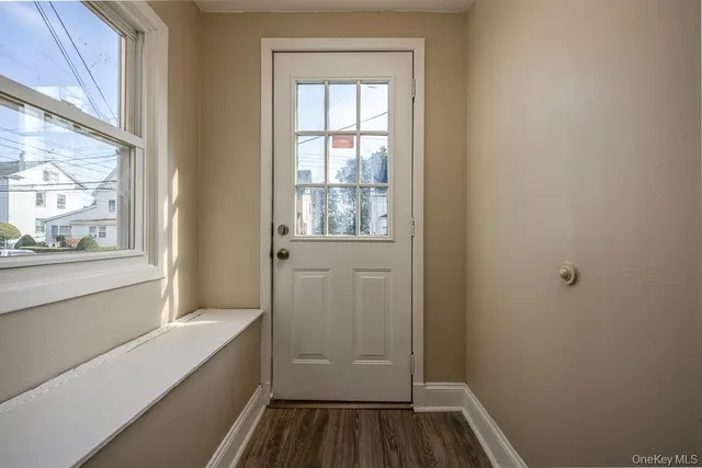 a kitchen with granite countertop a sink a stove and cabinets
