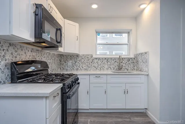 a bathroom with a granite countertop sink toilet and bathtub