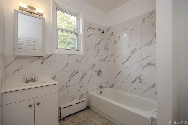 a view of an empty room with wooden floor and stairs